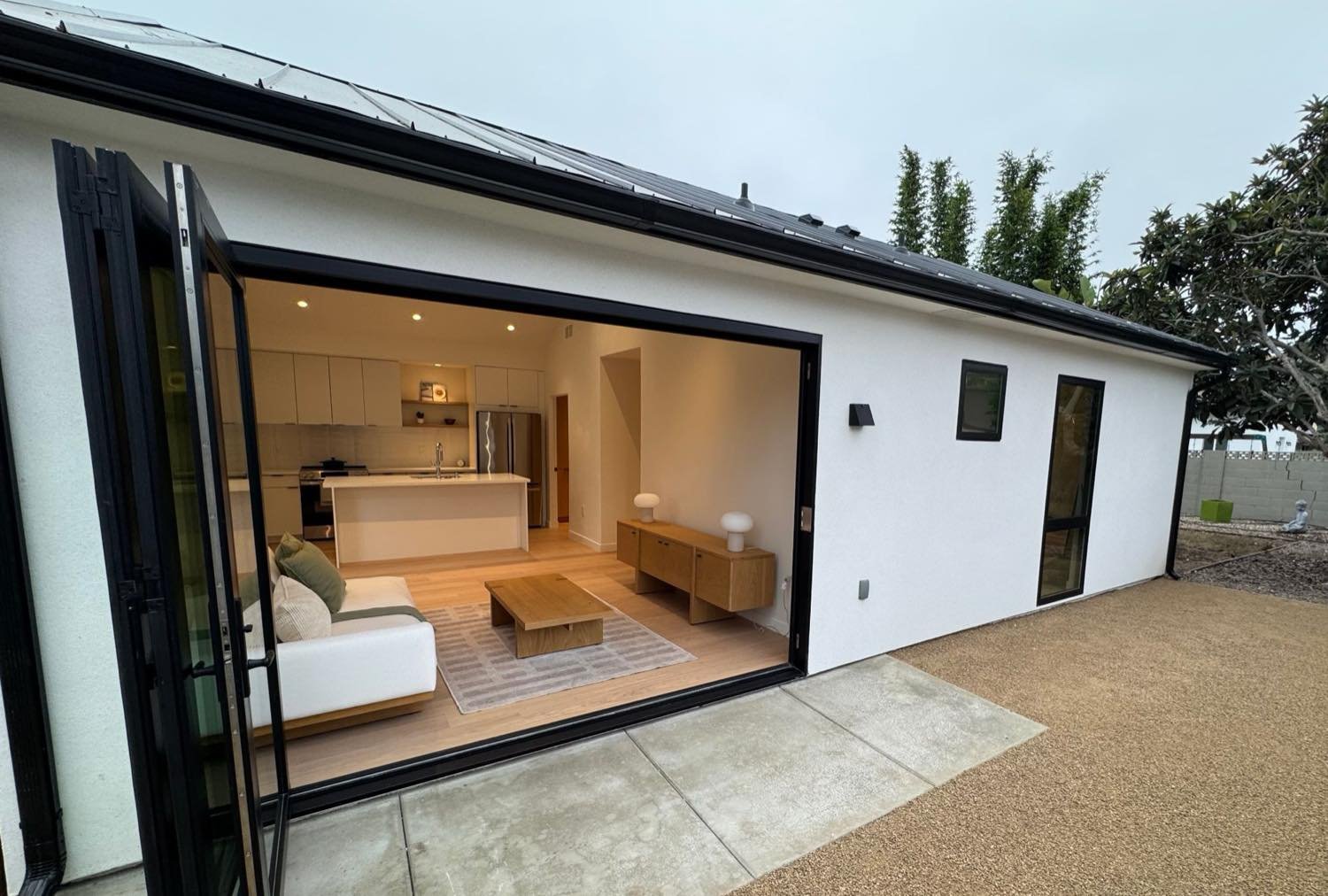 Detached ADU with folding glass doors open to the patio