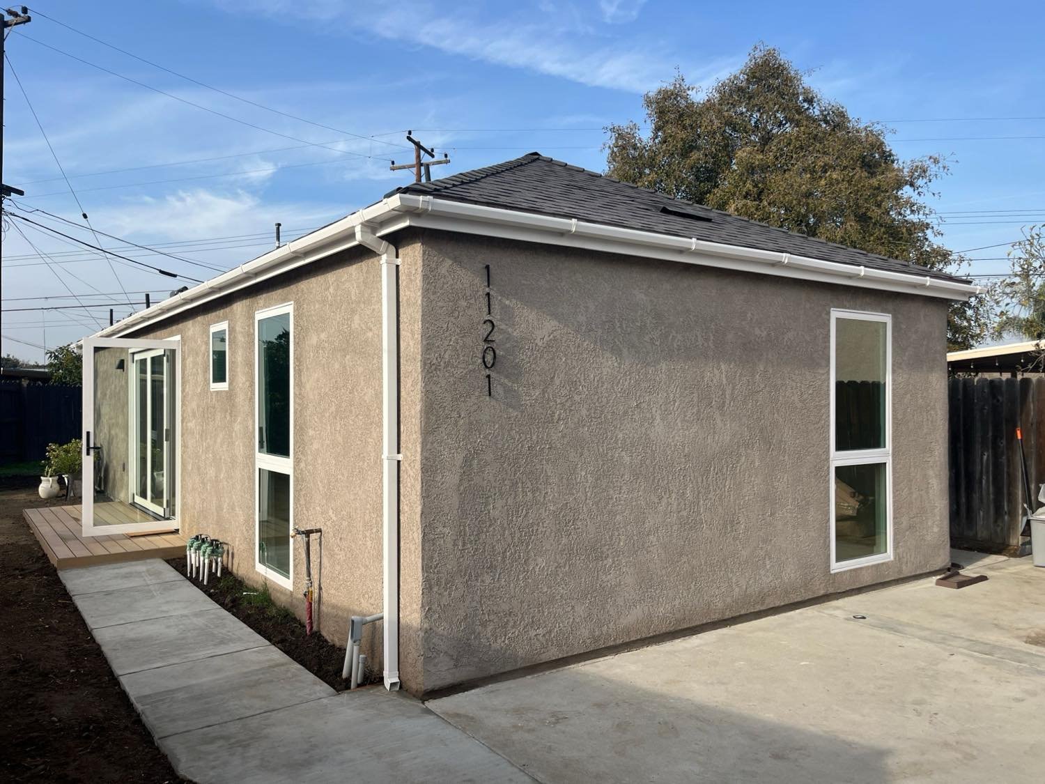 Newly built detached ADU with stucco exterior and tile roof
